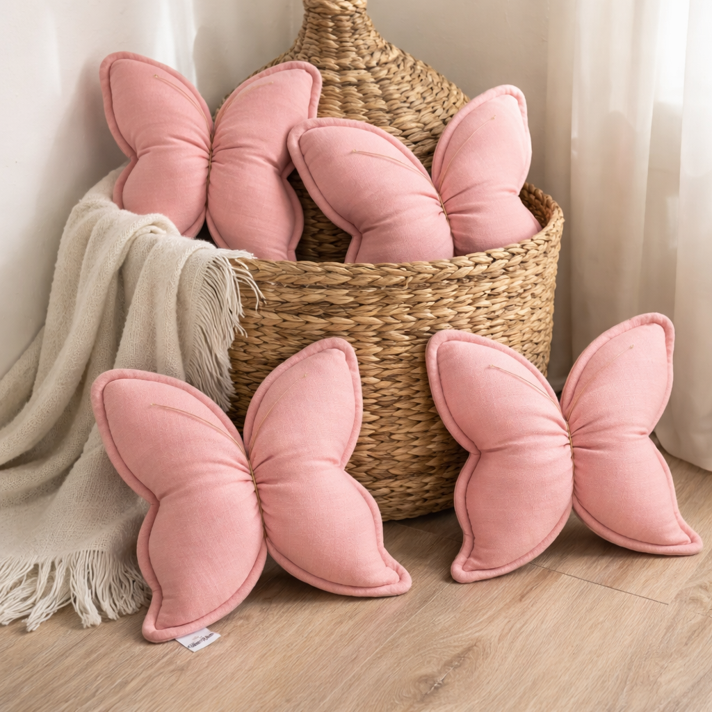Handmade pink butterfly pillow for nursery made from soft cotton muslin fabric