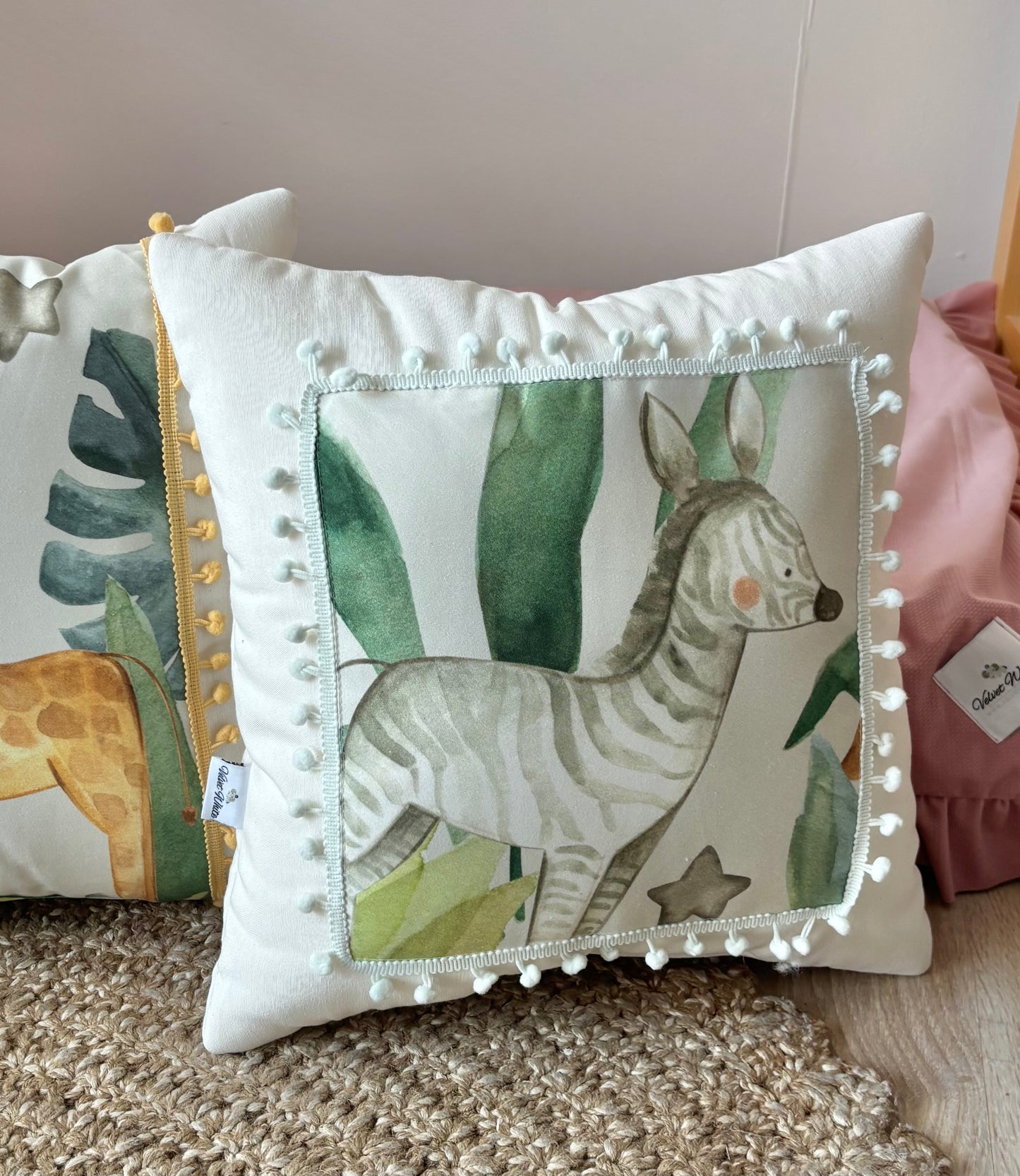 Safari nursery pillow set with lion, elephant, giraffe and zebra design in neutral kids room