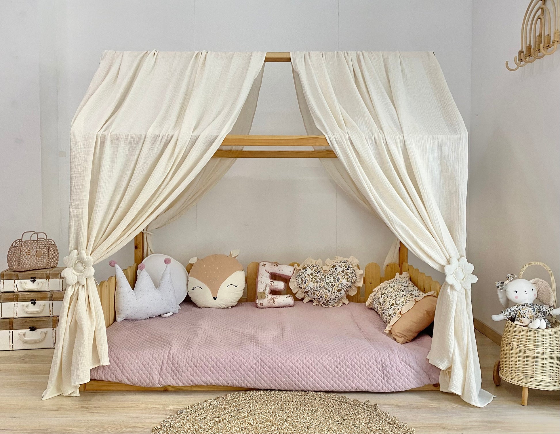 Cream canopy draped over Montessori floor bed
