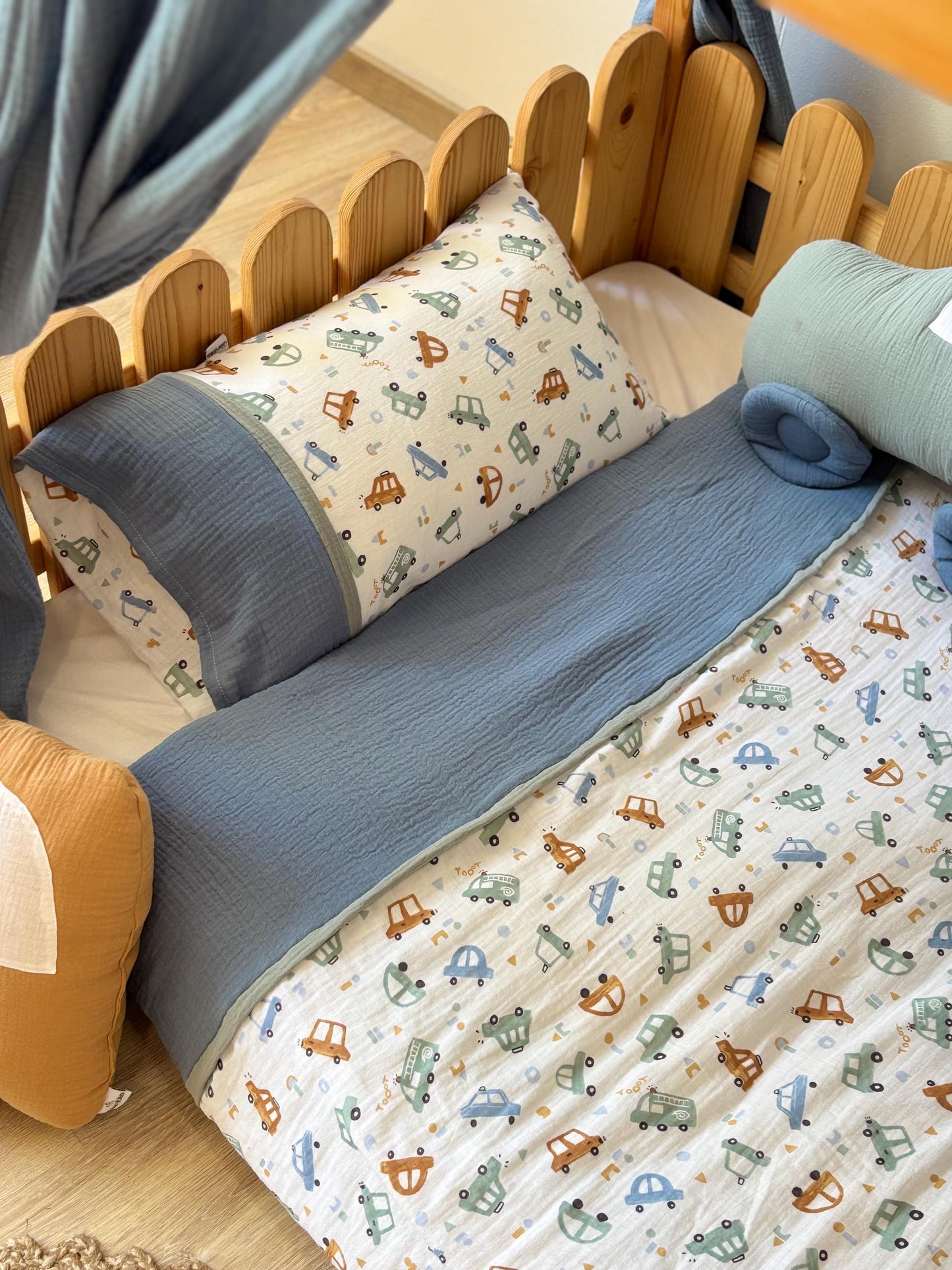 Handmade cotton muslin toddler duvet cover set with cars print styling on wooden Montessori kids bed
