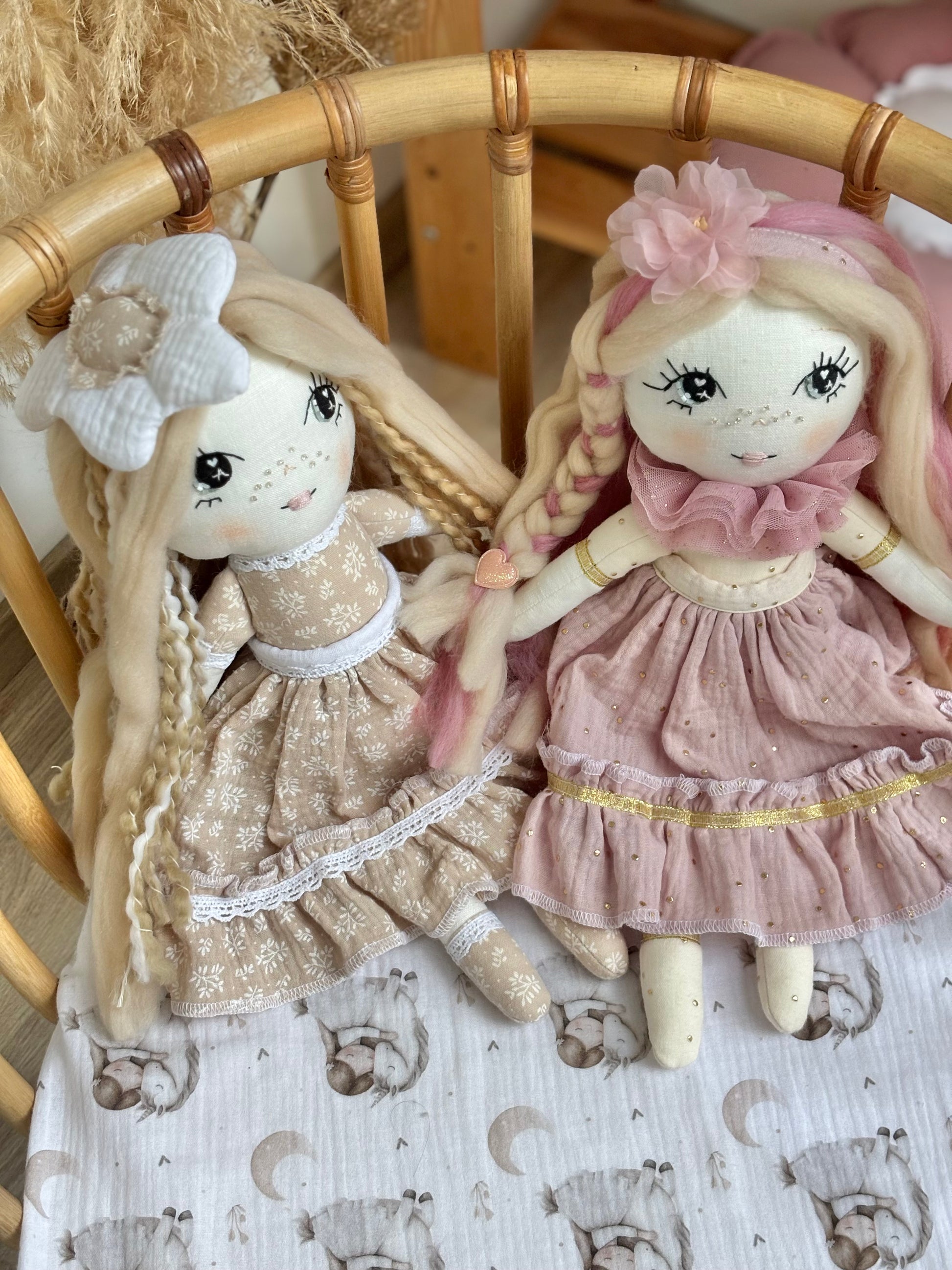 Handmade cloth doll in blush pink dress with hand-stitched face and long hair, heirloom fabric doll for nursery décor and baby gift