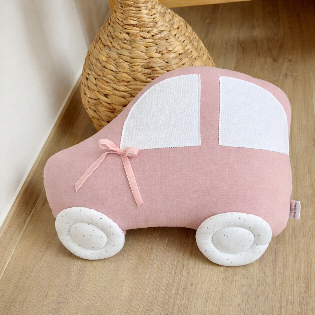 Pink handmade car shaped pillow for kids room in cotton muslin fabric with white windows and decorative bow