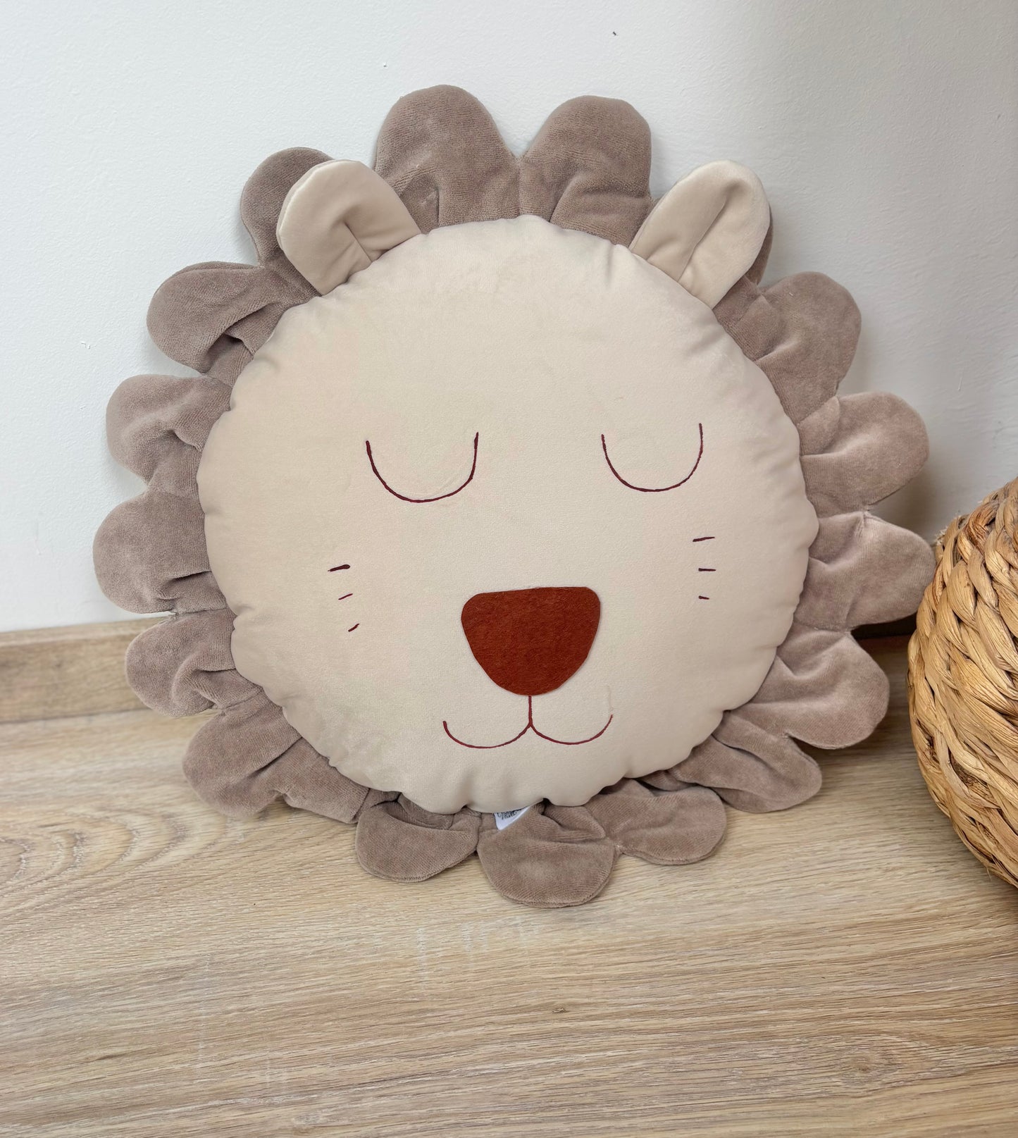 Handmade lion pillow in neutral tones for safari nursery decor in kids room