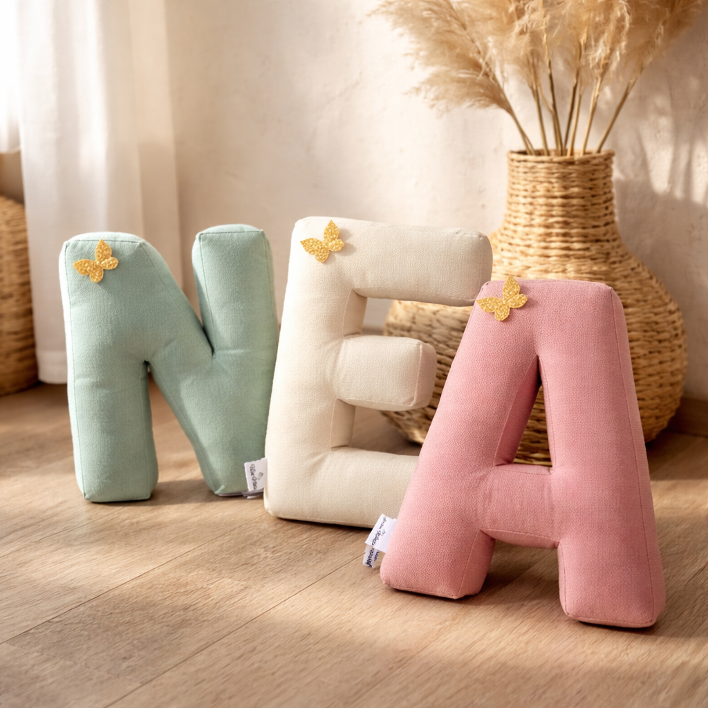 Personalized alphabet letter pillows spelling name in soft neutral nursery setting