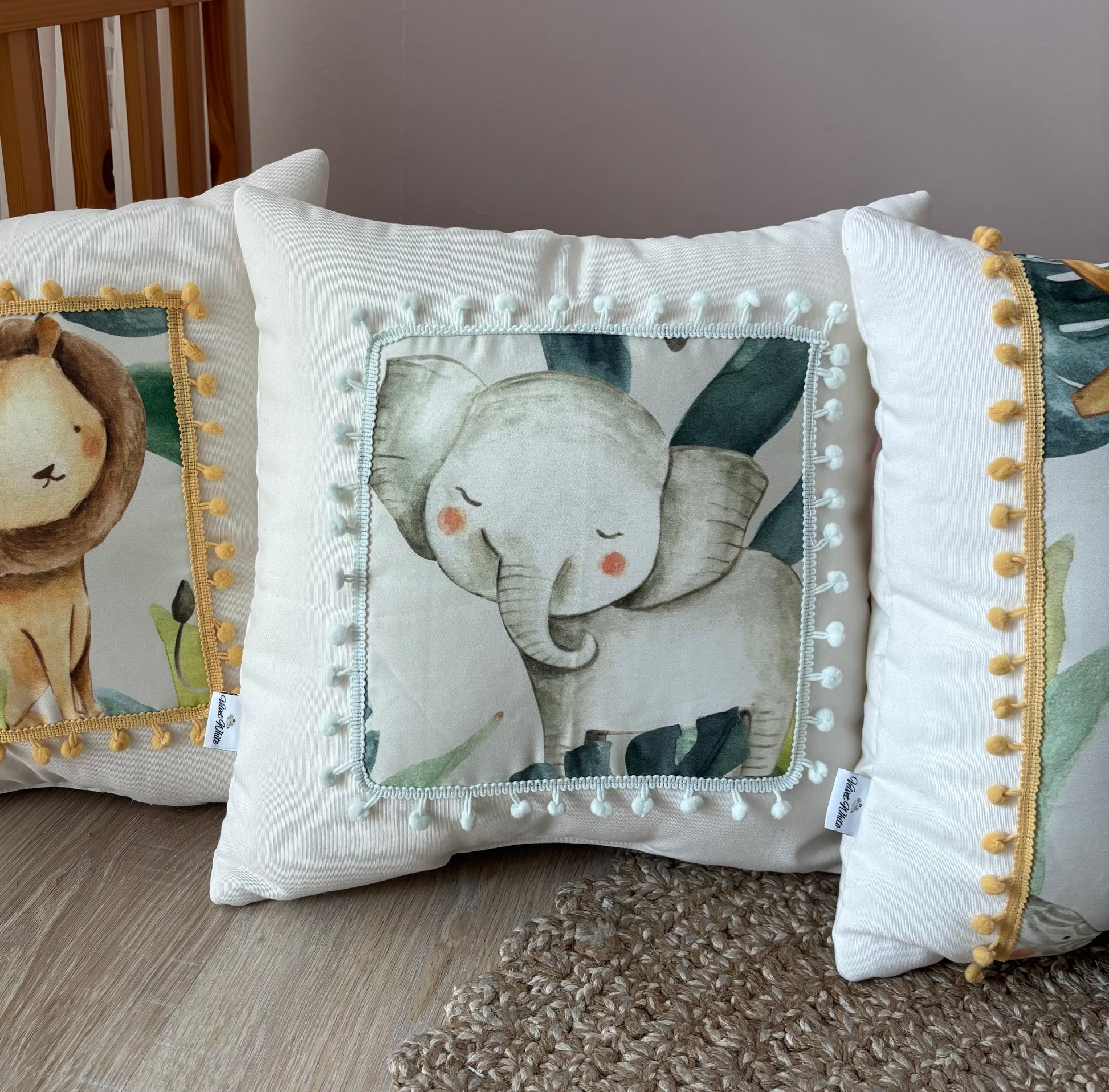 Safari nursery pillow set with lion, elephant, giraffe and zebra design in neutral kids room