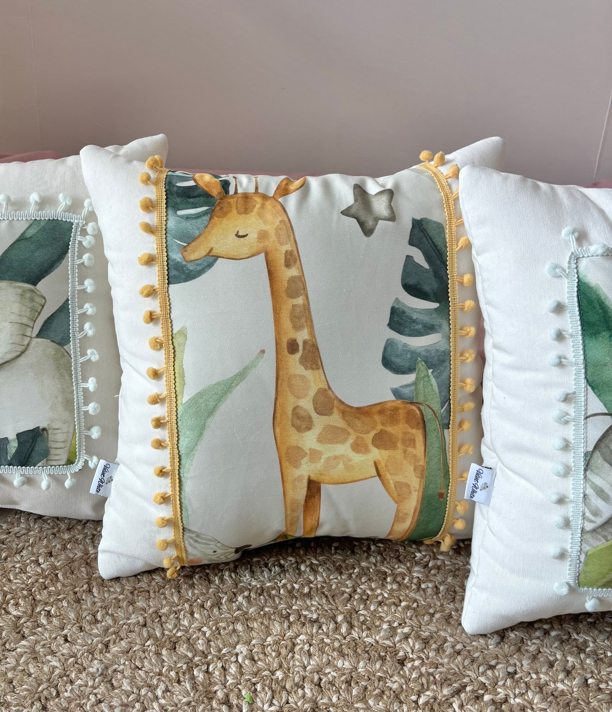Safari nursery pillow set with lion, elephant, giraffe and zebra design in neutral kids room