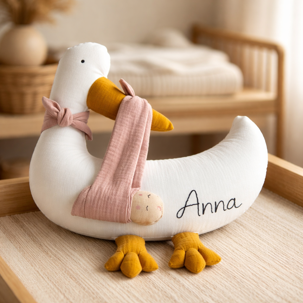 Personalized stork baby pillow with embroidered name in neutral nursery setting