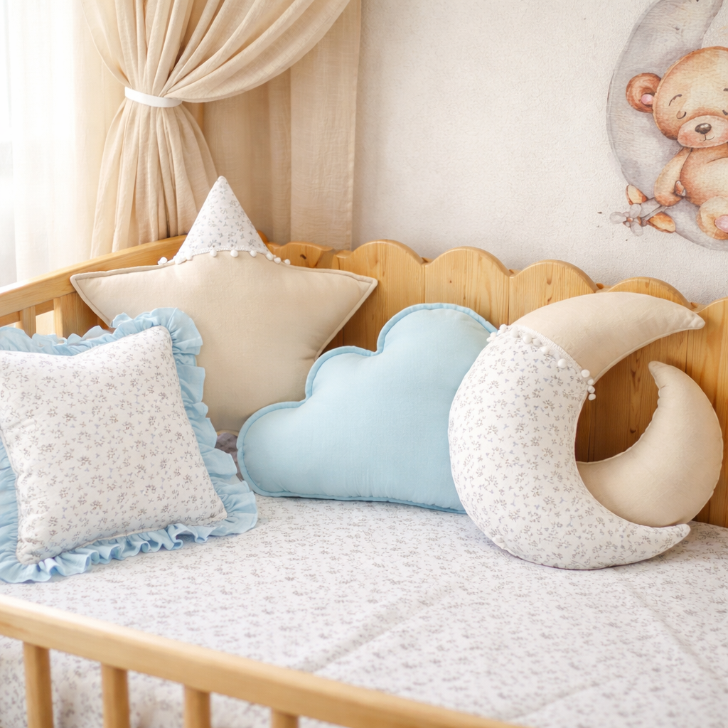 Children's room with decorative pillows shaped like a moon, cloud, and bear on a bed.