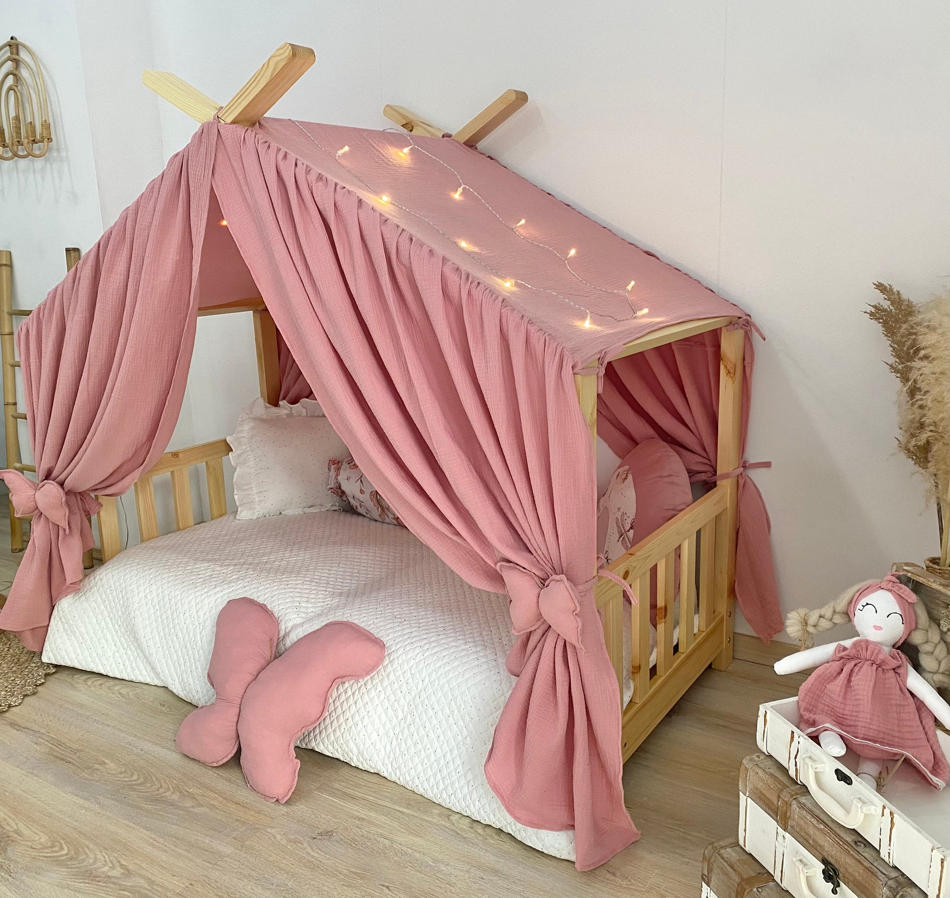 Blush pink canopy over Montessori floor bed