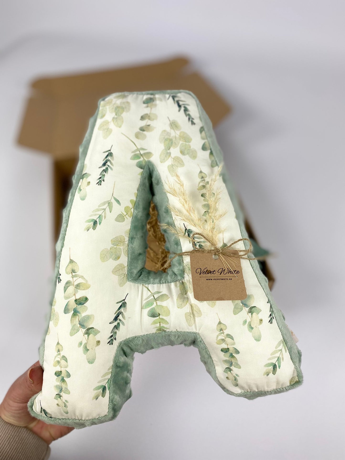 Personalized botanical letter A pillow in sage green for neutral nursery decor